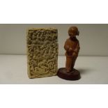 A 19th century ivory card case and a carved wood figure, the base of the card case with a boat