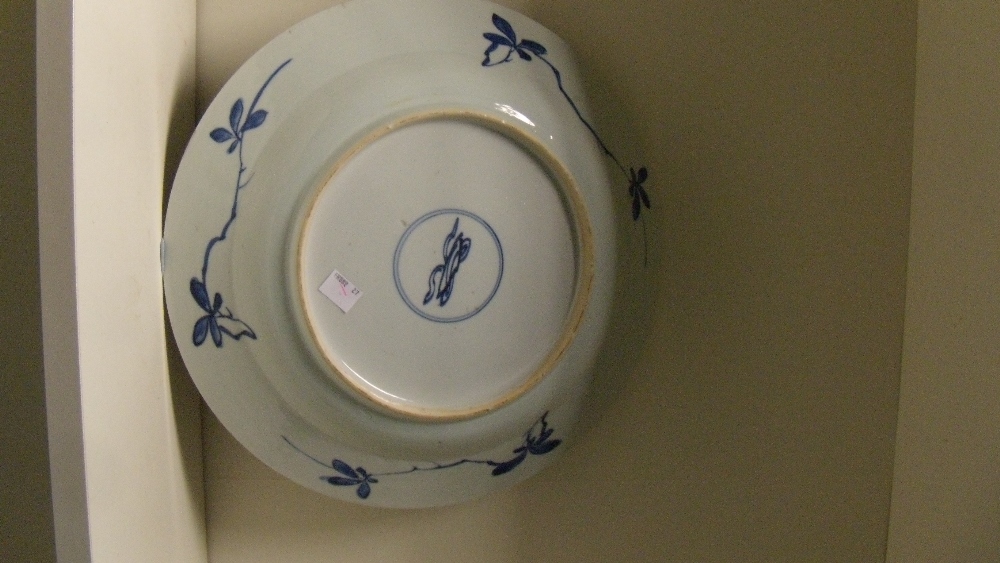 A blue and white dish, period of Kangxi, centrally painted with birds about a rock amongst peonies - Image 2 of 2