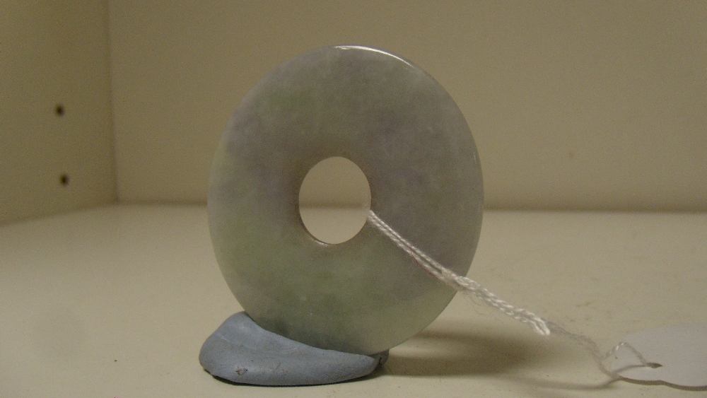 A jadeite bi, the mauve and green mottled white disc slightly rounded between the central hole and - Image 2 of 2