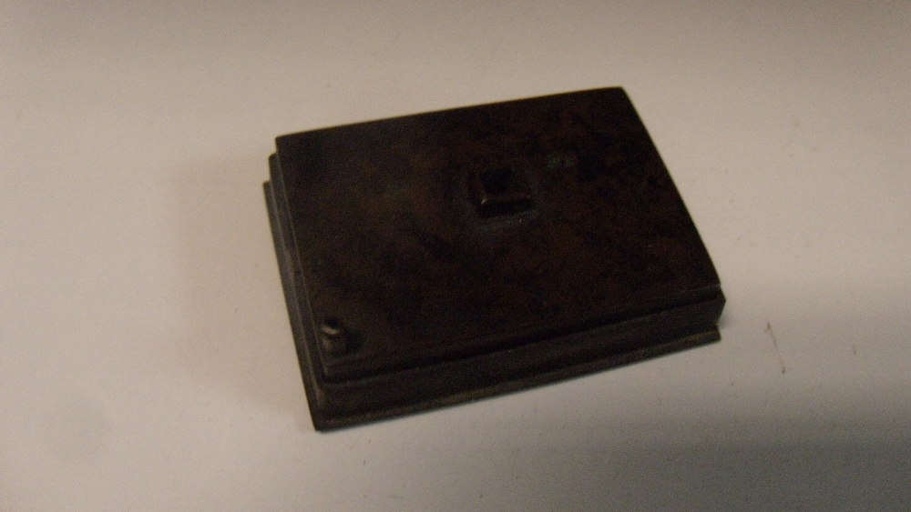 A 19th century bronze water dropper, the squat rectangular shape with a spout at one corner, 5cm (