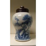 An 18th century blue and white baluster jar with wood cover, the sides painted with a continuous