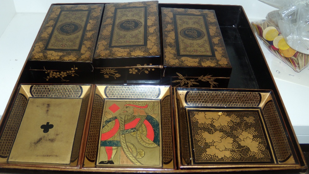 A mid 19th century black lacquer games box, gilt floral panels and grape vine bands enclosing the - Image 2 of 3