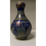 A blue ground famille rose onion topped bottle vase painted with mandarin ducks amongst lotus