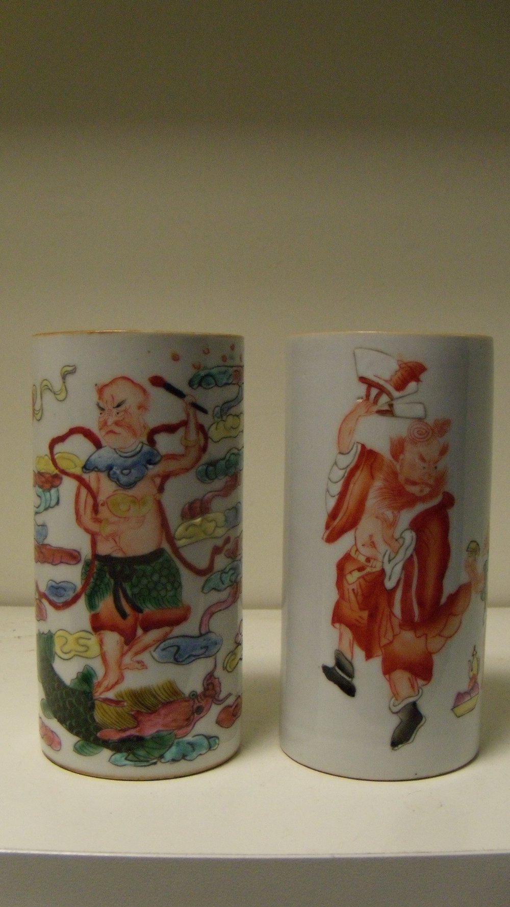 Two late 19th century brush pots, one of the cylindrical sides painted in iron red with Zhong Kui