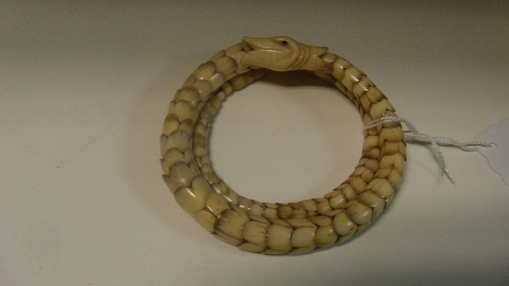 An ivory snake bracelet, the graded flower shaped links each with four petal tops interlinking to