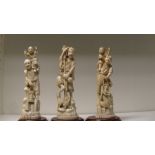 Three early 20th century marine ivory groups of artisans each standing on a rock with the