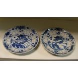 A pair of blue and white plates, period of Kangxi, the central carps and dragons rising from waves