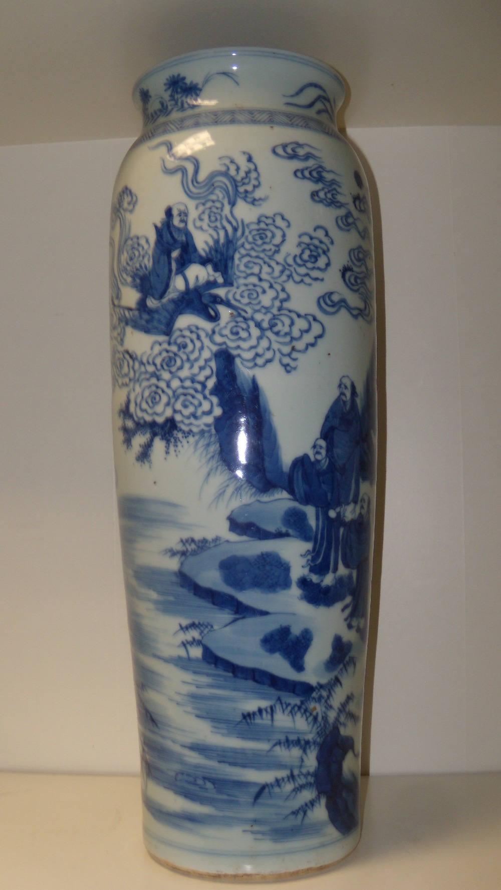 A Kangxi style blue and white vase, a cavetto neck and rounded shoulders above the tapering