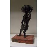 A 19th century bronze figure of an oni, the horned creature wearing a tiger skin lion cloth and