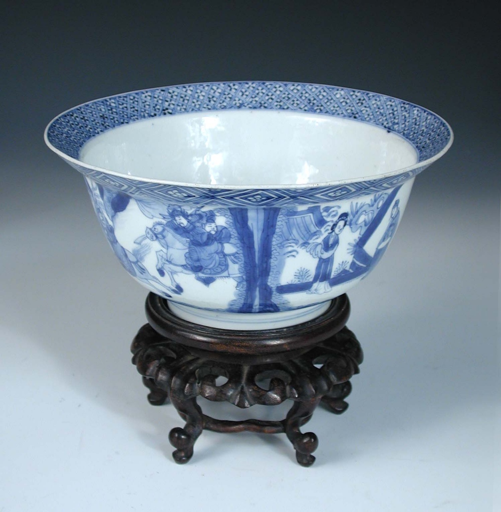 A blue and white bowl, six character mark and period of Kangxi, with hardwood stand, the flared