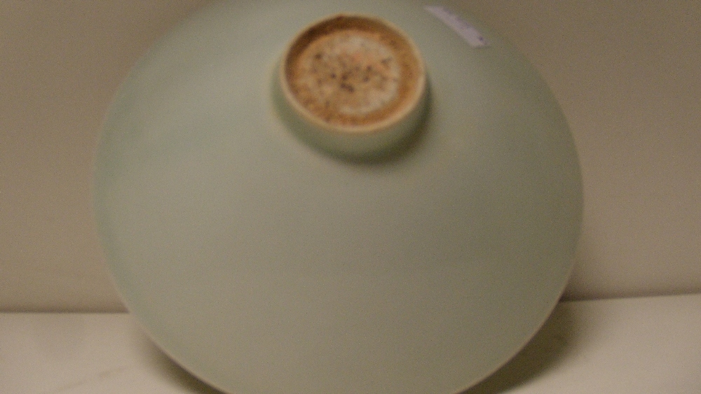 A yingqing bowl, the interior of the conical shape incised with three flower heads beneath the misty - Image 2 of 2