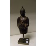 A Thai bronze of a standing Buddha, possibly 17th/18th century, he stands taking the cover off the