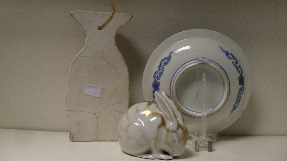 An Arita blue and white plate, a Kutani rabbit and and Imari wall pocket, the plate painted with a - Image 2 of 2