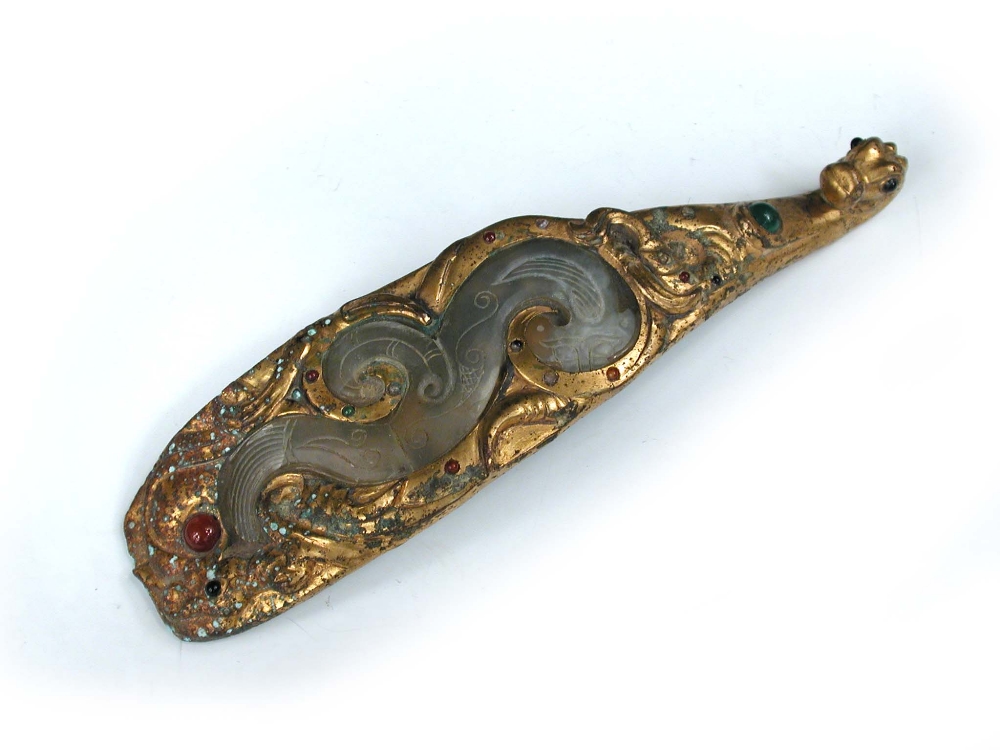 A gilt bronze jade inset belt hook, possibly Han dynasty, the sinuous green stone of the jade dragon