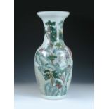 A famille rose baluster vase, the baluster shape painted with monks and immortals in a mountain