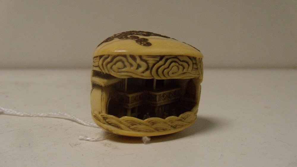 Mitsunobu, a 19th century ivory netsuke depicting the clam's dream, the shells of the mollusc gold