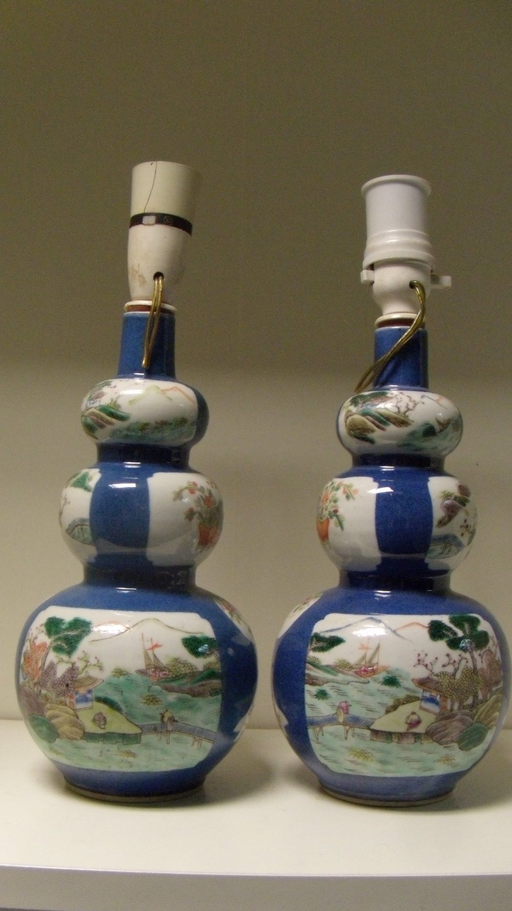 A pair of late 19th/early 20th century famille verte double gourd vases, the triple lobed bodies