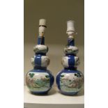 A pair of late 19th/early 20th century famille verte double gourd vases, the triple lobed bodies