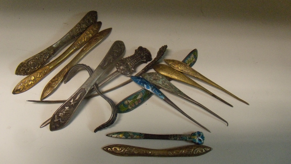 Fourteen hair pins and pieces, two with ornamental ends to pin shafts in white metal, four of