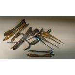 Fourteen hair pins and pieces, two with ornamental ends to pin shafts in white metal, four of