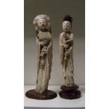 Two late 19th/early 20th century ivory figures of a dignitary and lady, he stands with a fan open at