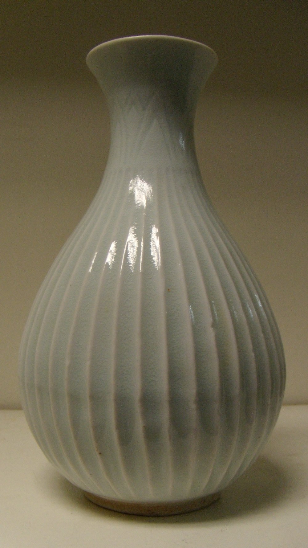 A yingqing glazed vase, possibly Korean, the lanceolate leaves incised below the flared rim above