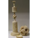 A late 19th/early 20th century ivory ball within ball carving and stand, the exterior of the ball