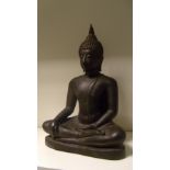 A 19th century Burmese bronze Buddha sitting cross legged on a triangular base in dhyanasana, his