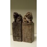 A pair of 19th century soapstone seals, each of the square sectioned bodies surmounted with seated