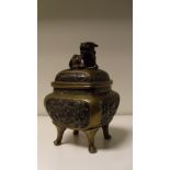 A late 19th/early20th century bronze koro and cover, the rounded square sides cast with flower and