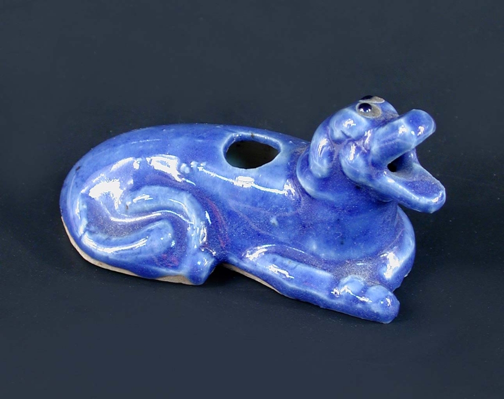 An 18th/19th century blue glazed beast water dropper, the roaring mouth of the reclining beast