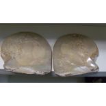 A pair of late 19th/early 20th century mother of pearl shells carved in relief on the nacreous sides