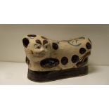 A Cizhou pillow modelled in the form of a leopard reclining on a black cushion, its back inscribed