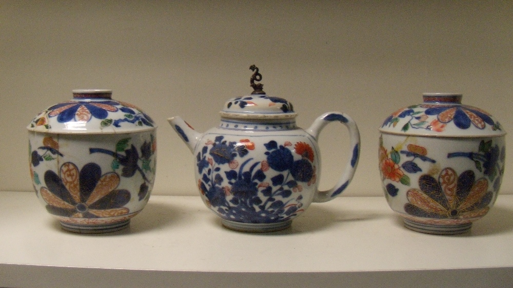 An 18th century Imari tea pot, a pair of Japanese Imari bowls and covers, the compressed spherical