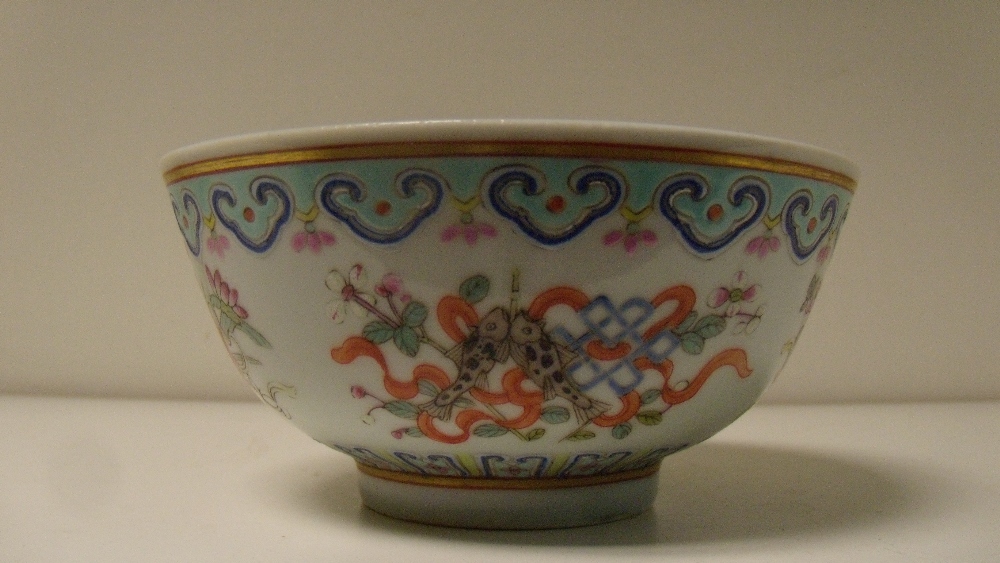 A bowl, six character mark of Guangxu in red, the exterior painted with four groups of Buddhist