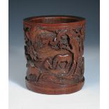 A 19th century bamboo brush pot, the exterior carved in relief with men minding horses under pine