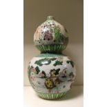 A famille verte double gourd vase painted with bands of figures in gardens outside pavilions, the