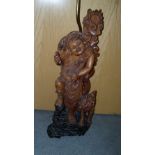 A 20th century hardwood figure of Liu Hai with familiar toad standing below the sun, once holding