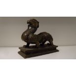 A 20th century bronze figure of a bixie, the mythical beast walking across a rectangular base