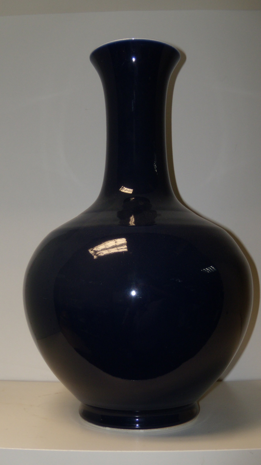 A blue glazed bottle vase, six character mark of Guangxu, the flared rim, slender cylindrical neck