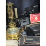 A quantity of cameras, a miners lamp and a brass cased ships wheel style barometer