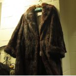 A mink fur coat, together with two other fur coats and a silk dress