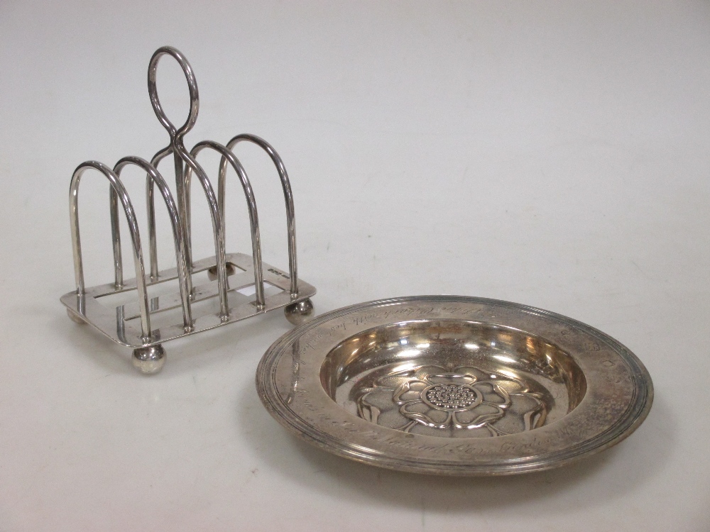 A silver toast rack and a small armada dish