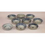 A collection of thirteen blue and white bowls