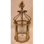 An 18th century style brass framed hall lantern, with hanging chains and mount