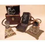A leather cased Rolliflex camera, another and two glass inkwells