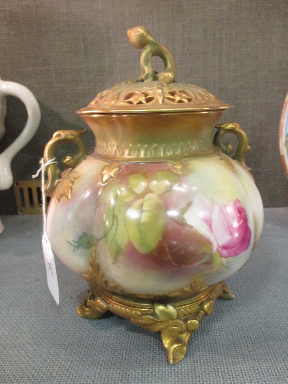 An early 20th century Worcester pot pourri vase and cover painted with roses, 19cm high