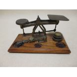 A set of brass postal scales and a sovereign scale, together with a two handled vase (3)