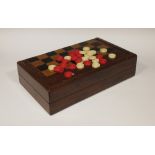 An early 20th century folding chess/backgammon board with Chinese counters