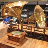 An early 20th century walnut cased Continental gramophone with three brass horns and various LP